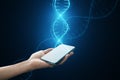 Close up of female hands holding cellphone with glowing DNA helix hologram on background. Medicine and bioengineering concept