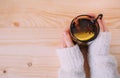 Close up of female hands holding cup of warm water with lemon Royalty Free Stock Photo