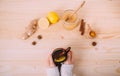 Close up of female hands holding cup of warm water with lemon Royalty Free Stock Photo