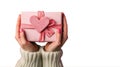 Close up on female hands holding a gift in a pink heart presents for valentine day, birthday, mother\'s day Royalty Free Stock Photo