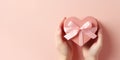 Close up on female hands holding a gift in a pink heart presents for valentine day, birthday, mother\'s day. Royalty Free Stock Photo