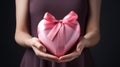 Close-up on female hands holding gift of pink heart presents. Valentine's Day, Mother's Day. Royalty Free Stock Photo