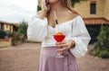 Close up of female hands holding glasses of acohol cocktail with fresh fruts and berries Royalty Free Stock Photo