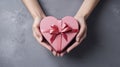 Symbol of Love. Close-Up on Female Hands Holding a Heart-Shaped Gift for Valentine's Day, Birthday, Mother's Day