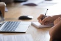 Close up female hands holding pen writing in notepad Royalty Free Stock Photo