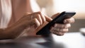 Close up female hands holding phone, typing on screen