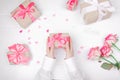 Close up on female hands holding presents for valentine day, birthday, mother`s day or christmas. Flat lay Royalty Free Stock Photo