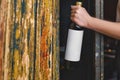 Close up of female hands holding red wine bottle with white blank label against shelf of wine old cabinet in restaurant