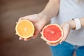 Orange and grapefruit in human`s hands. Royalty Free Stock Photo