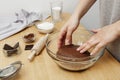 Close up of female hands kneading raw chocolate dough at home for cooking cookies Royalty Free Stock Photo