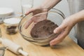 Close up of female hands kneading raw chocolate dough at home for cooking cookies Royalty Free Stock Photo