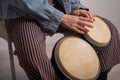 Close-up of female hands on mini bongo drums. The girl plays a traditional ethnic percussion instrument Royalty Free Stock Photo