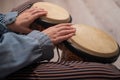 Close-up of female hands on mini bongo drums. The girl plays a traditional ethnic percussion instrument Royalty Free Stock Photo
