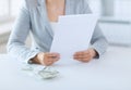 Close up of female hands with money and tax report Royalty Free Stock Photo