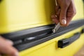 Close-up of female hands packing and locking bag for holidays trip. Latino woman preparing travel suitcase. Close-up of Royalty Free Stock Photo