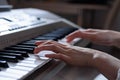 Close-up of female hands playing the sequencer, shallow depth of field Royalty Free Stock Photo