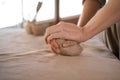 Close-up of female hands of a potter she kneads a piece of raw clay. the concept of favorite hobby is modeling. banner. Royalty Free Stock Photo