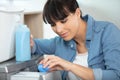 close-up female hands pouring detergent in washing machine