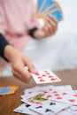 Close up of female hands putting cards while playing cards Royalty Free Stock Photo