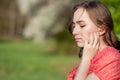 Close-up Of Female Hands Putting Hearing Aid In Ear. Modern digital in the ear hearing aid for deafness and the hard of hearing Royalty Free Stock Photo