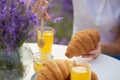 Female hands putting honey on croissants in lavender field. Royalty Free Stock Photo