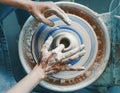 hands sculpting clay on a Potter`s wheel. Concept of hobby and cretivity at home and in the Studio workshop