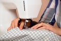 Close-up female hands sewing fabric on sewing machine Royalty Free Stock Photo