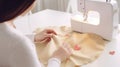 Close-up of female hands sewing a heart on the fabric. Royalty Free Stock Photo