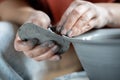 Ceramist using metal rib for pottery shaping, potter working with clay on wheel Royalty Free Stock Photo