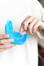 Close-up of female hands show case with transparent aligners inside, fingers put braces in case Royalty Free Stock Photo