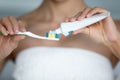 Closeup view woman squeezes toothpaste to toothbrush from tube Royalty Free Stock Photo