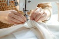 Close up female hands stitch white fabric on modern sewing machine Royalty Free Stock Photo