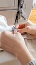 Close up female hands stitch white fabric on modern sewing machine Royalty Free Stock Photo