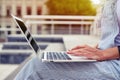 Close-up of female hands on touchpad of laptop outdoors Royalty Free Stock Photo