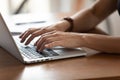 Close up female hands typing on keyboard, using laptop Royalty Free Stock Photo