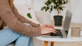 Close up female hands typing laptop at living room. Unrecognizable business woman with computer work at home office sit Royalty Free Stock Photo