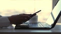 close-up, female hands typing something on a laptop keyboard. At the same time, a business woman responds to messages in Royalty Free Stock Photo