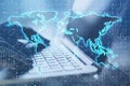 Close up of female hands using laptop computer on desktop with glowing binary code map hologram on blurry background. Software and Royalty Free Stock Photo