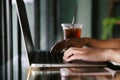 Close up of female hands using laptop in modern office or loft near by the window Royalty Free Stock Photo