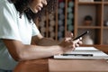 Close up of female hands using modern smartphone at office, businesswoman typing on cellphone text message