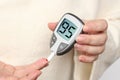 Close-up female hands, woman makes test with lancet pen and glucometer, Medicine, glycemia, healthcare and medical concept