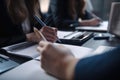 Close up of female hands writing in notebook at table in office, Business members doing brainstorming processes, AI Generated