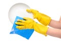 Close up of female hands in yellow protective rubber gloves washing white plate with blue rag Royalty Free Stock Photo