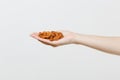 Close up female hold in hand brown unprocessed almonds nuts isolated on white background. Proper nutrition, vegan food Royalty Free Stock Photo