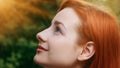 Close-up female inspired pretty profile face attractive model teenage beautiful redhead girl stands outside sunbeams Royalty Free Stock Photo