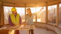 CLOSE UP: Female investor points up to ceiling while discussing floor plans.