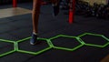 Close-up of female legs doing cardio intense workout using agility ladder