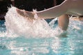 Close-up of female legs in a pool of water. lady resting in the summer at the resort makes splashes of water.