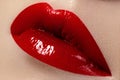 Close-up of female lips with bright makeup. Macro of woman's face. Fashion lip make-up with red gloss