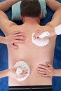 Female massage hands give herbs hot ball therapy for man